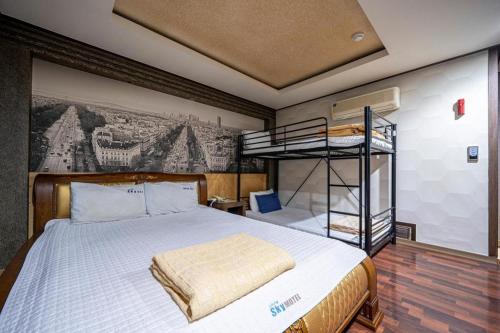 a bedroom with a bed and bunk beds in it at SKY Hotel in Changwon