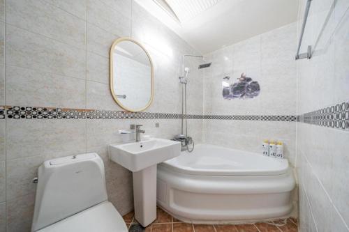 a bathroom with a sink and a toilet and a mirror at Luxury Motel Daejeon in Daejeon