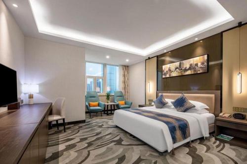 a hotel room with a bed and a television at Shaanxi Business Hotel in Shanghai