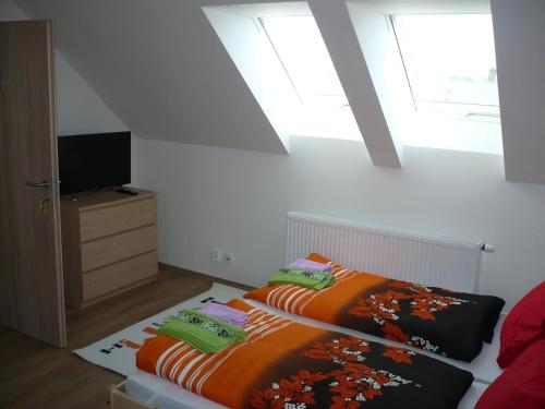 a bedroom with a bed with an orange blanket at Rivendell Apartments in Prague