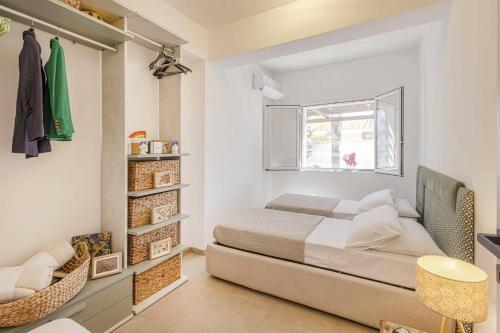a bedroom with a bed and a window at Villa Arenella by Villa Plus in Arenella