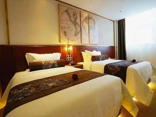 a hotel room with two beds in it at James Joyce Coffetel Beijing Yizhuang Rongjing East Street Subway Station in Beijing