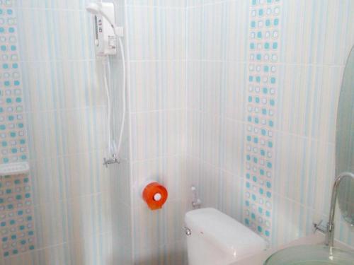 a bathroom with a shower with a toilet in it at Green Home Resort in Surat Thani