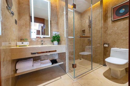 a bathroom with a shower and a toilet and a sink at MeiQiu-Fino Hotel in Zhuhai