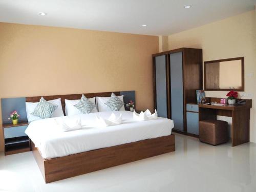a bedroom with a large white bed in a room at Regent Room Hotel in Suratthani