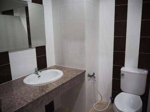 a bathroom with a sink and a toilet at Regent Room Hotel in Suratthani