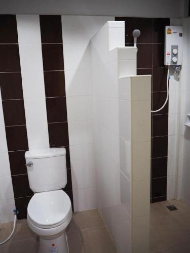 a bathroom with a white toilet in a room at Regent Room Hotel in Suratthani