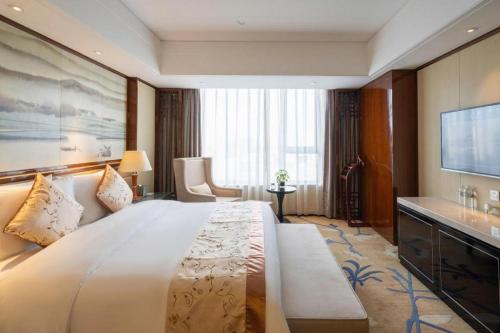 Ένα ή περισσότερα κρεβάτια σε δωμάτιο στο Yang Peng Jin Jiang Hotel