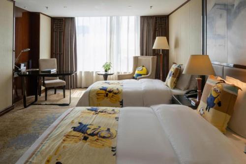 Ένα ή περισσότερα κρεβάτια σε δωμάτιο στο Yang Peng Jin Jiang Hotel