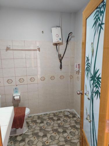 a bathroom with a shower with a toilet and a sink at Grand Thai House Resort Lamai in Lamai
