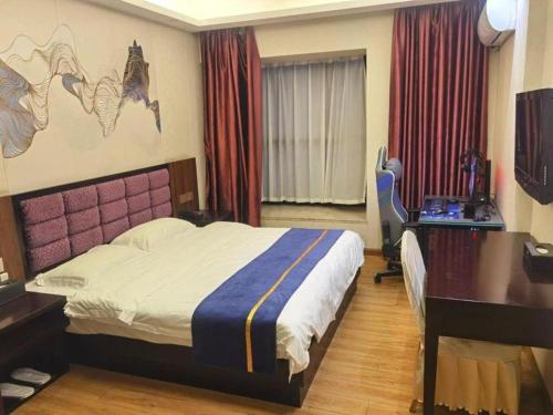 a hotel room with a bed and a desk and a desk at Oriental Hotel in Dongguan