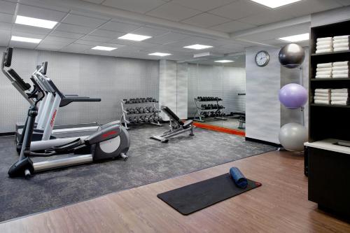 a gym with treadmills and exercise bikes and a clock at Fairfield by Marriott Inn & Suites Asheville Outlets in Asheville