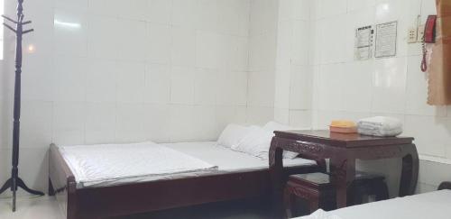 a room with a bed and a table with a phone at Trung Luong Hotel 2 in My Tho