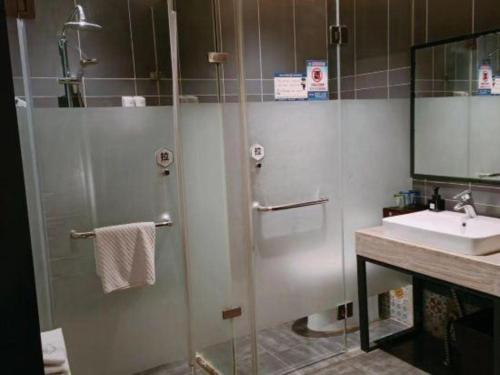 a bathroom with a shower and a sink at Hangzhou Berman Hotel in Hangzhou
