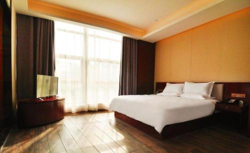 a hotel room with a bed and a large window at Hangzhou Berman Hotel in Hangzhou