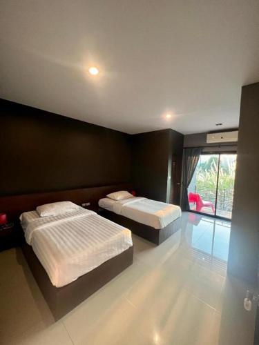 Katil atau katil-katil dalam bilik di Nangfa Mini Hotel