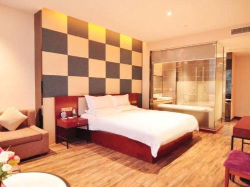 a bedroom with a large bed and a bathroom at Hangzhou Berman Hotel in Hangzhou