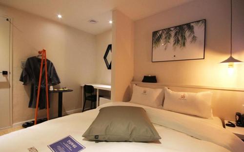 a hotel room with a bed and a dressing table at Hotel Yam ANDONG in Andong