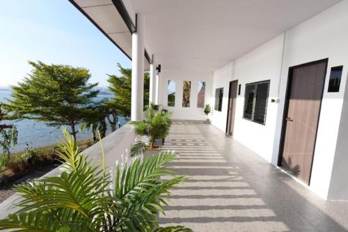 a hallway of a house with a view of the ocean at Rim Kaeng resort in Phetchaburi