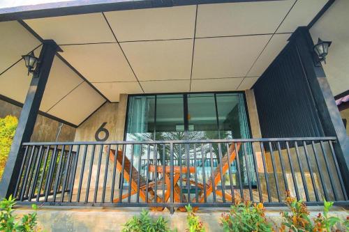 a balcony of a building with a glass window at Rim Kaeng resort in Phetchaburi