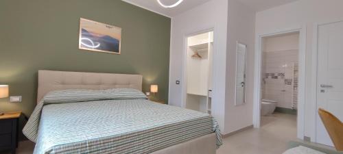 a bedroom with a bed and a bathroom at B&B Terra Camerte in Camerino