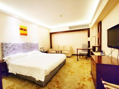 a hotel room with a bed and a flat screen tv at Starmoon Hotel in Beijing