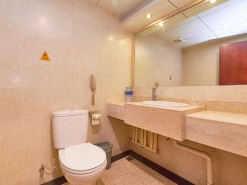 a bathroom with a toilet and a sink at Starmoon Hotel in Beijing