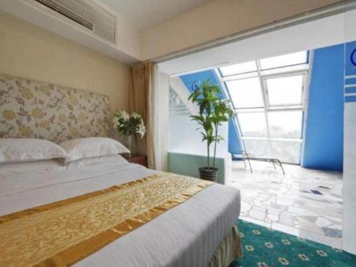 a bedroom with a bed and a large window at Starmoon Hotel in Beijing