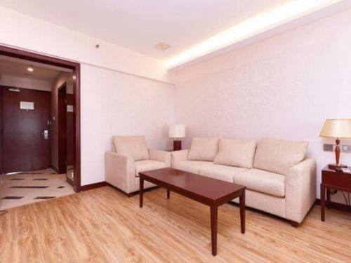 a living room with a couch and a table at Starmoon Hotel in Beijing