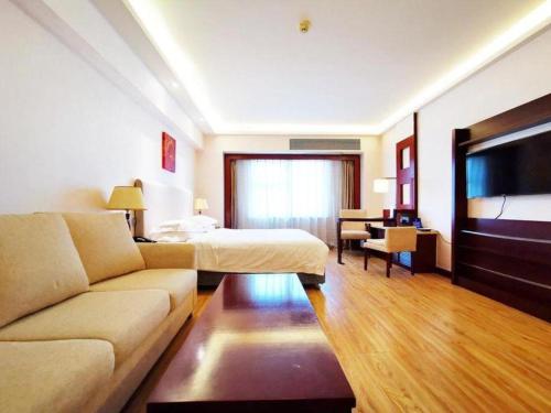 a hotel room with a couch and a bed at Starmoon Hotel in Beijing