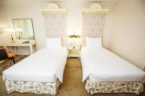 Postel nebo postele na pokoji v ubytování Regency Art Hotel
