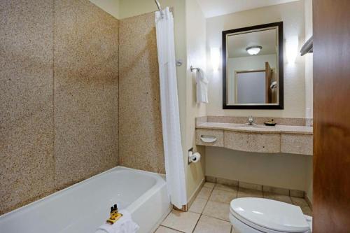 a bathroom with a tub and a toilet and a sink at Best Western Plus Guymon Hotel and Suites in Guymon
