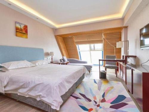 a bedroom with a bed and a table and a desk at Starmoon Hotel in Beijing
