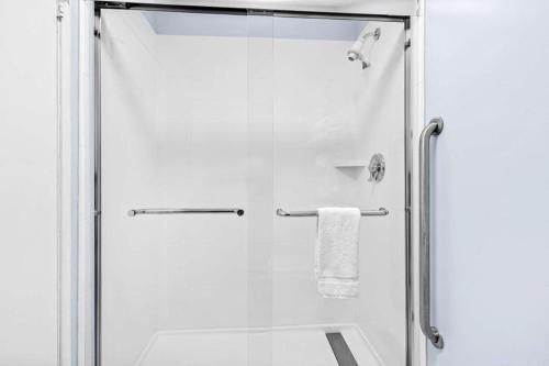 a shower with a glass door with a towel at Best Western Vista Manor Lodge in Fort Bragg