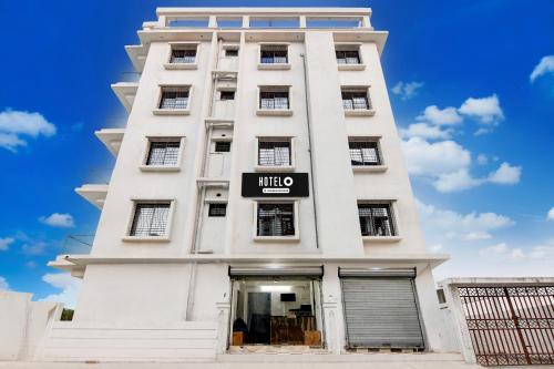 a white building with a sign on it at Super Hotel O New Town Near Downtown Mall in Pānchuria