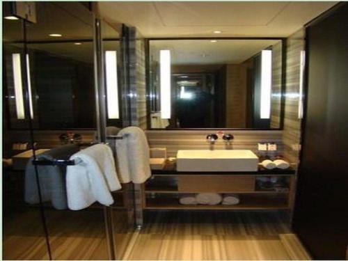 a bathroom with a sink and a large mirror at Best Western Plus Fuzhou Fortune Hotel in Fuzhou