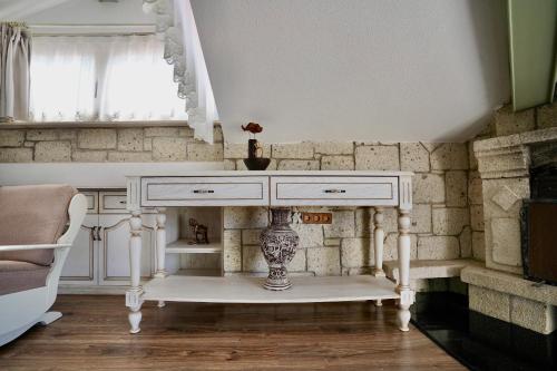 a white console table in a room with a window at Cumbalıca Flora in Cesme