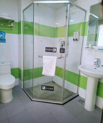 a bathroom with a shower and a toilet and a sink at 7 Days Inn Hohhot Hailiang Xinhua Square Metro Station in Hohhot