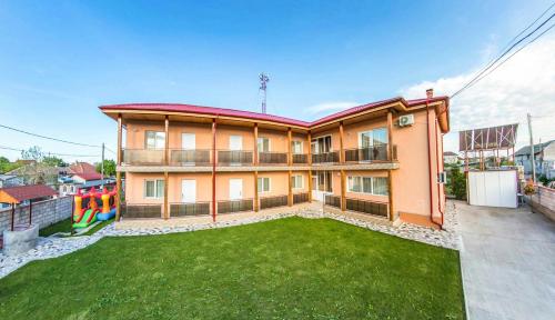 a house with a lawn in front of it at Vila Sophia in Vama Veche