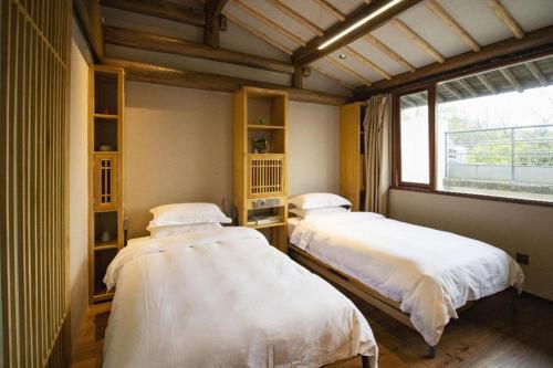 Voodi või voodid majutusasutuse Hangzhou Teavilla Hotel toas