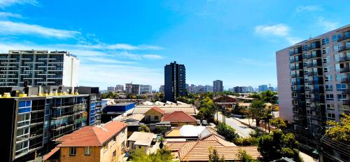 a view of a city with tall buildings at Moderno y Comodo Departamento en Ñuñoa 2D1B Piso 6 in Santiago