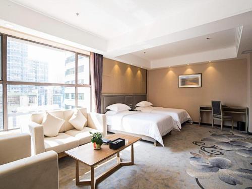 a hotel room with a bed and a couch at Guangzhou Rongjin hotel in Guangzhou