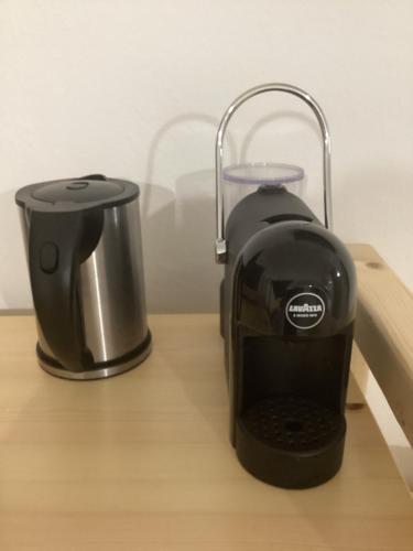 a toaster sitting on top of a wooden table at B&B Les Chambres Rooms & Suite in Santa Teresa Gallura