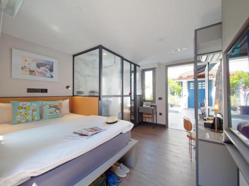 a bedroom with a large bed in a room at Hotel Soloha @ Chinatown in Singapore