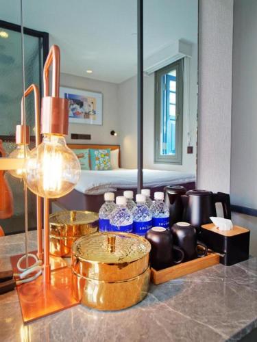 a room with a bunch of bottles on a counter at Hotel Soloha @ Chinatown in Singapore