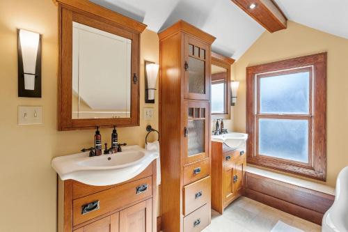 a bathroom with two sinks and a mirror at Urban Oasis in Minneapolis