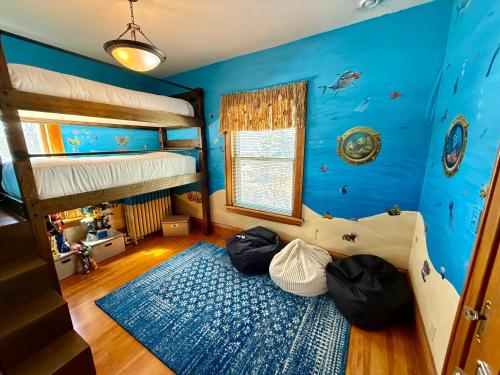 a room with two bunk beds and a blue wall at Urban Oasis in Minneapolis