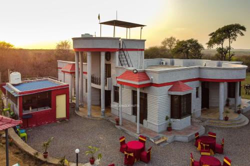 a model of a house with tables and chairs at The Jungle Huts 6BHK With PVT Pool in Gurgaon