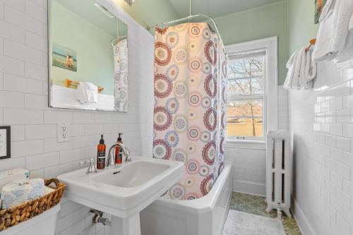 a bathroom with a sink and a shower curtain at Uptown Urban Living in Minneapolis