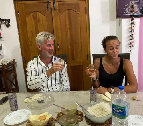 a man and a woman sitting at a table drinking wine at Divine Homestay Kandy in Kandy